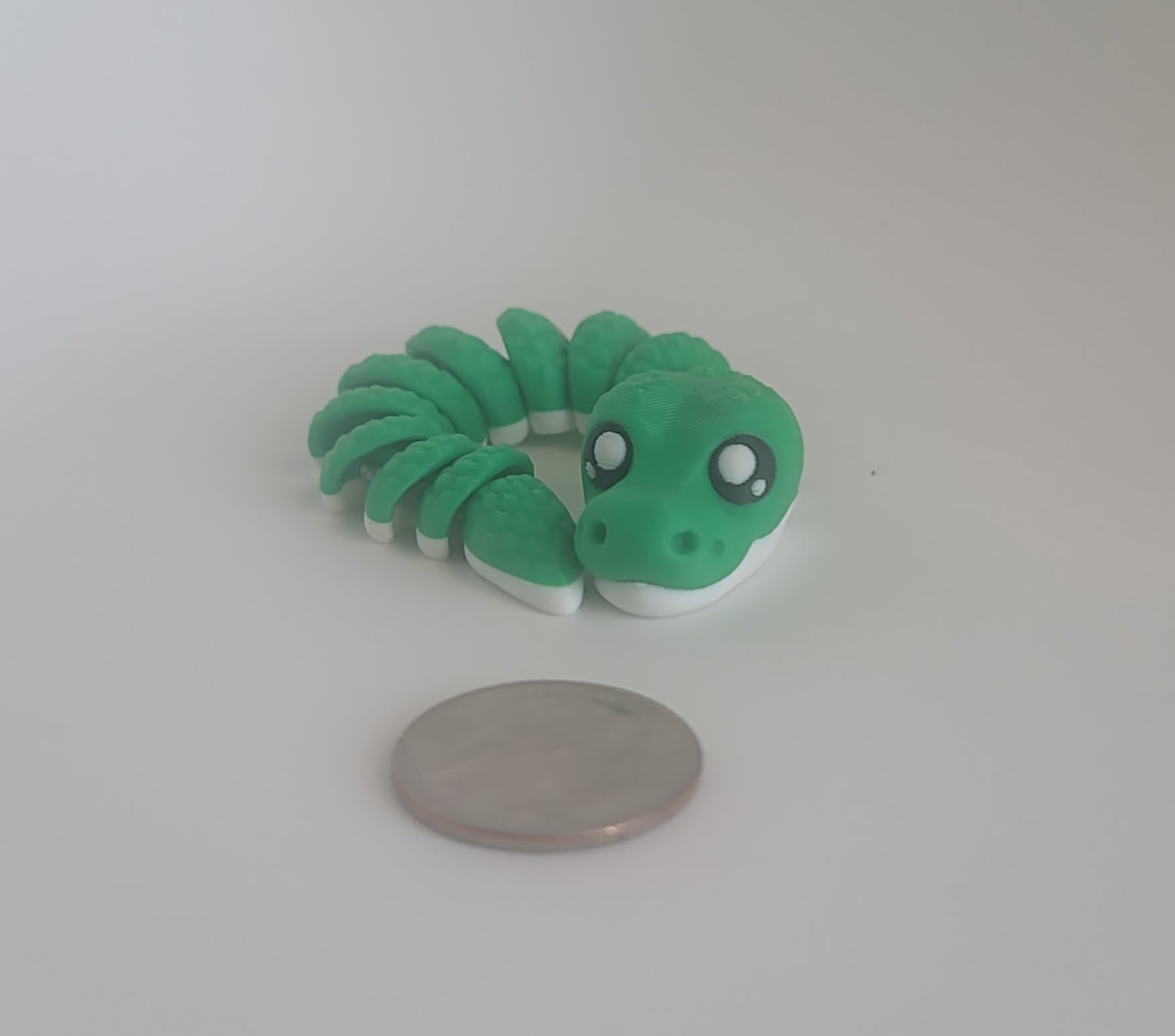 Flexi snake keychain coiled view, fully articulated 3D printed reptile, Woody Burns