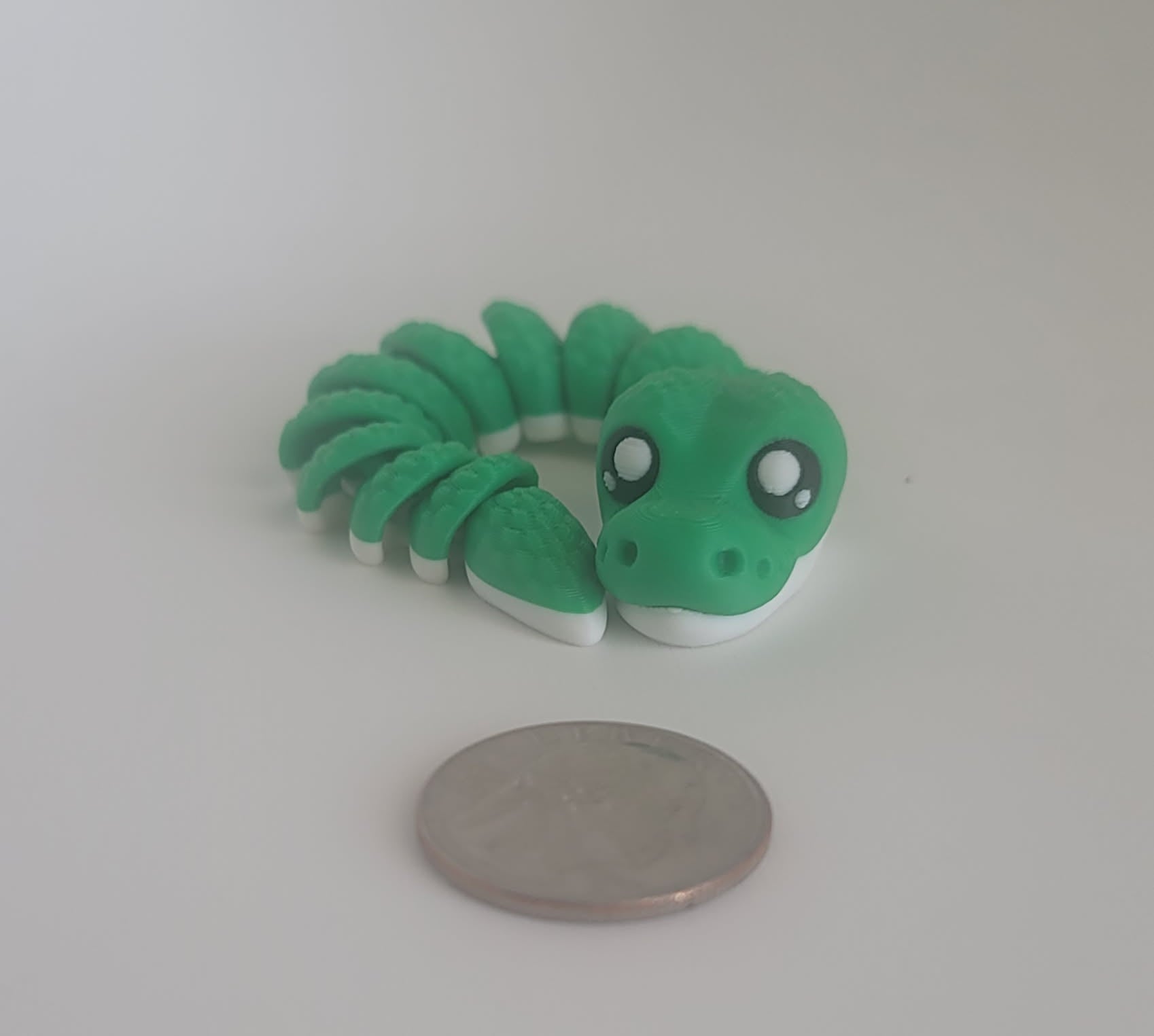 Green flexi snake keychain stretched out showing all segments, 3D printed handmade Reno NV